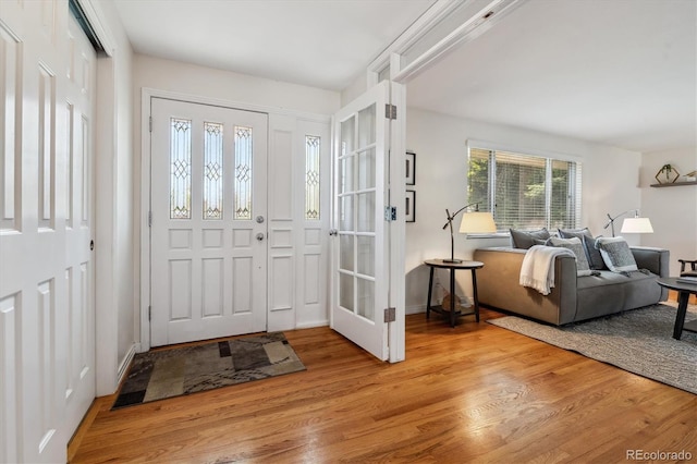 foyer featuring light wood finished floors and baseboards