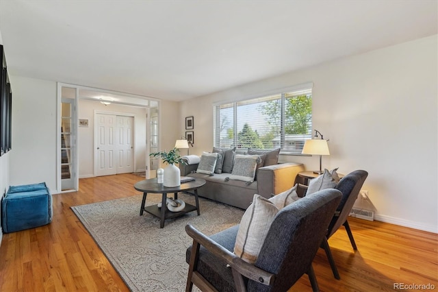 living room with light wood-style flooring and baseboards