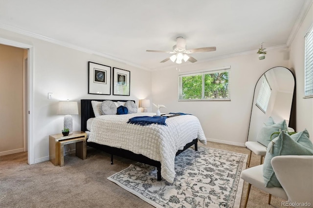 bedroom featuring light colored carpet, ornamental molding, baseboards, and a ceiling fan