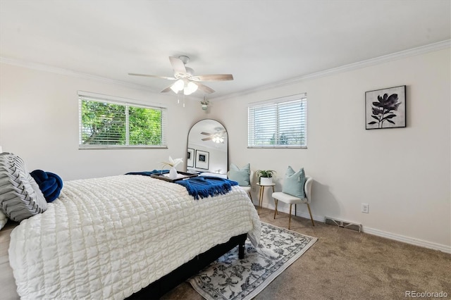 carpeted bedroom with ornamental molding, multiple windows, ceiling fan, and baseboards