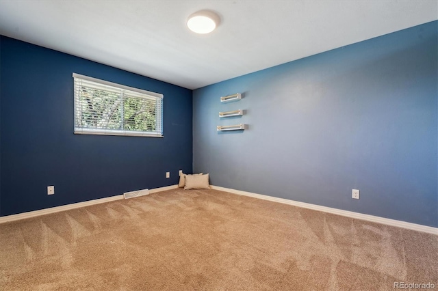 carpeted empty room with baseboards
