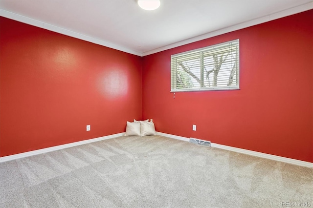 carpeted empty room with baseboards