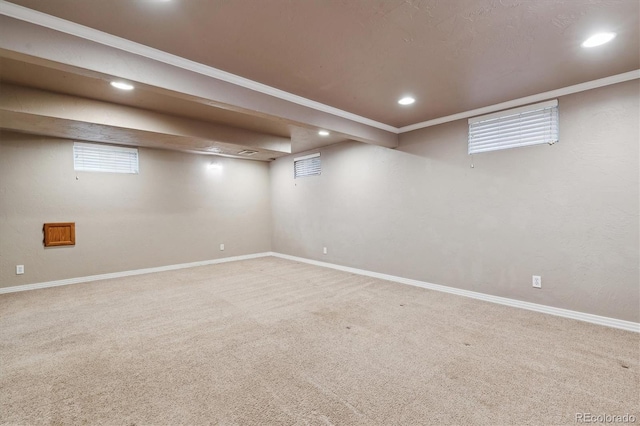 below grade area with recessed lighting, crown molding, carpet flooring, and baseboards