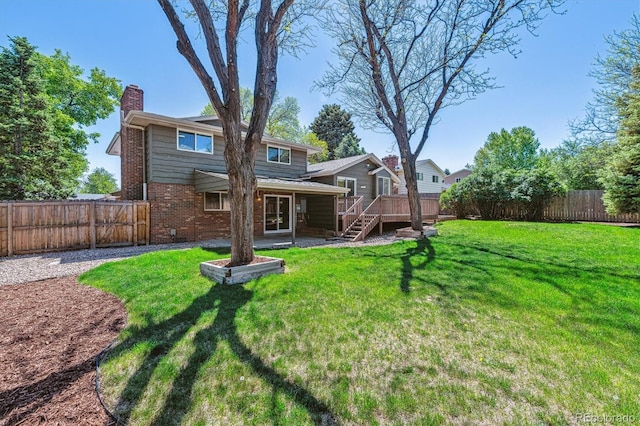back of property featuring a chimney, brick siding, a wooden deck, and stairs