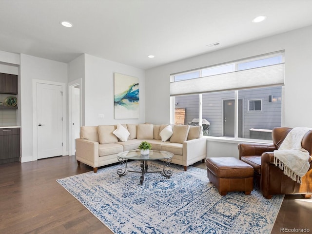 living area with wood finished floors, recessed lighting, and baseboards