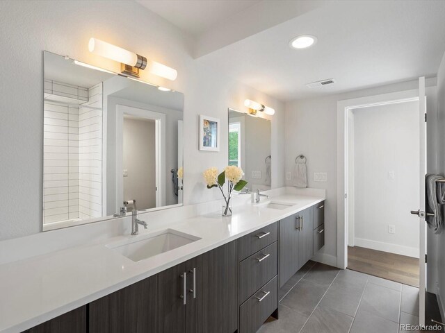 full bathroom with tile patterned floors, double vanity, baseboards, and recessed lighting
