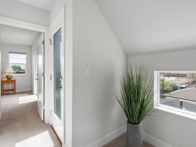 hall with light carpet and baseboards