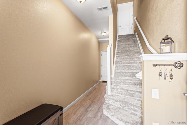 staircase featuring hardwood / wood-style flooring