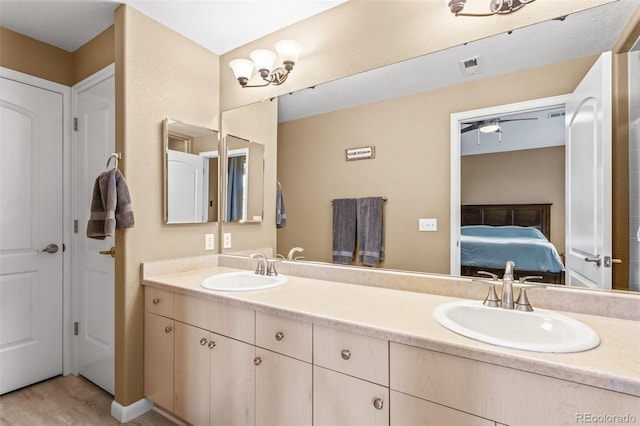 bathroom featuring wood-type flooring, ceiling fan, and vanity