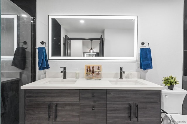 bathroom featuring vanity, toilet, and an enclosed shower