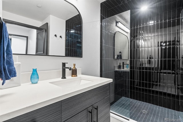 bathroom featuring vanity and a tile shower