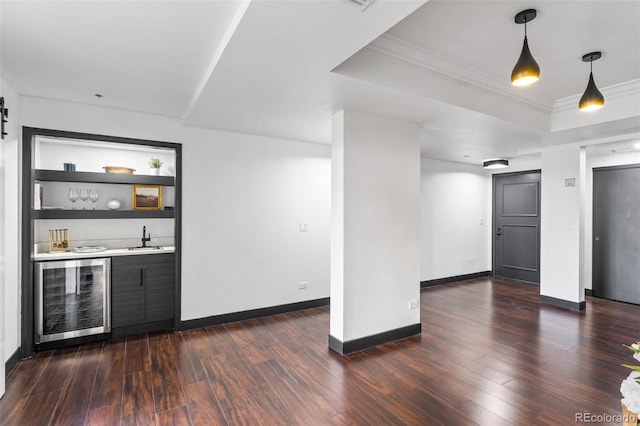 bar with wine cooler, sink, ornamental molding, dark hardwood / wood-style floors, and a raised ceiling