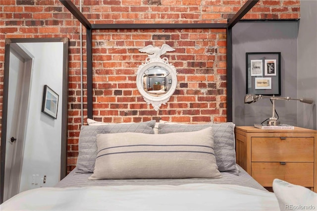 bedroom featuring brick wall