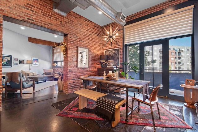 dining area featuring recessed lighting, a high ceiling, a notable chandelier, and brick wall