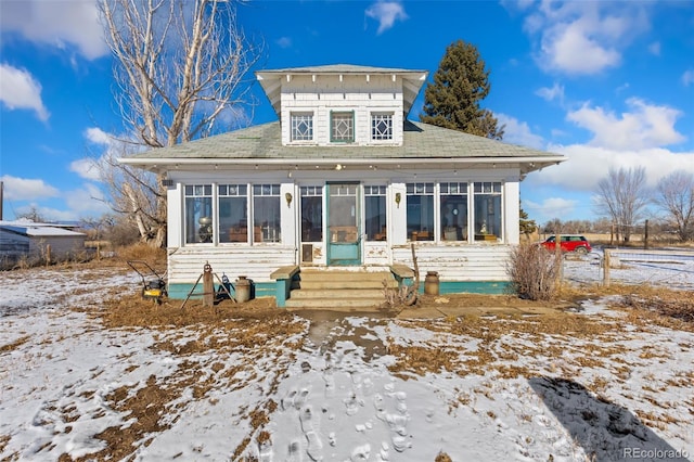 view of front of house with a sunroom