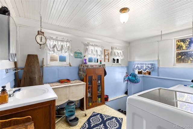 laundry area featuring crown molding, sink, and washer / dryer