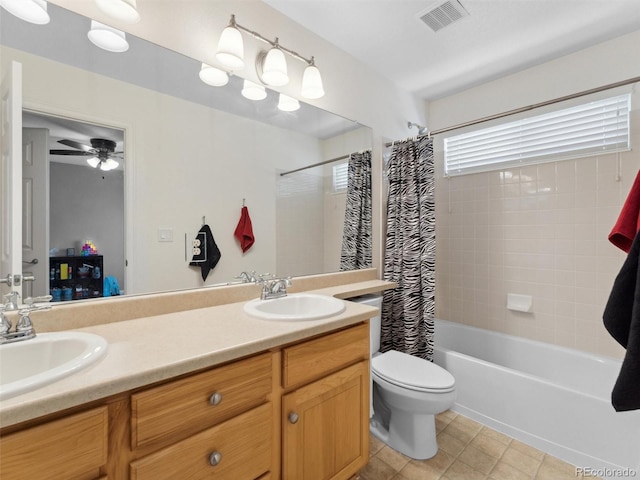 bathroom featuring toilet, double vanity, tile patterned flooring, shower / bath combo with shower curtain, and ceiling fan