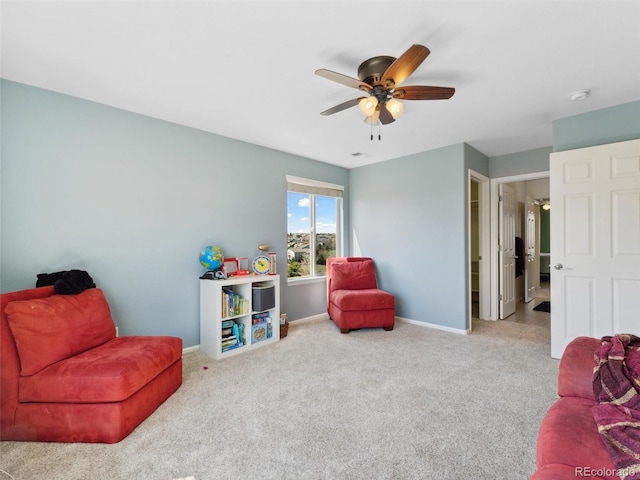 sitting room with ceiling fan, baseboards, and carpet flooring