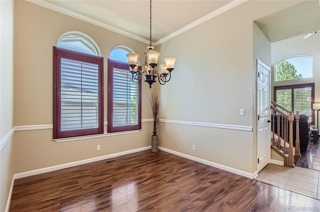23029 Cleveland Dr, Parker, CO 80138 - empty room featuring wood finished floors, a chandelier, and crown molding