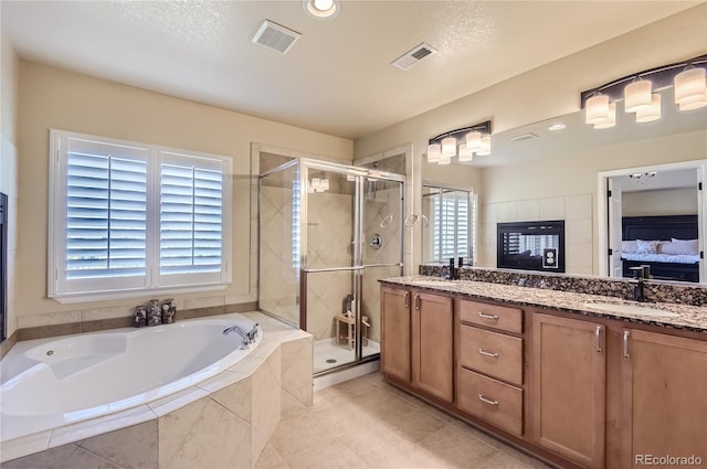 23029 Cleveland Dr, Parker, CO 80138 - ensuite bathroom featuring a garden tub, a stall shower, double vanity, tile patterned flooring, and recessed lighting