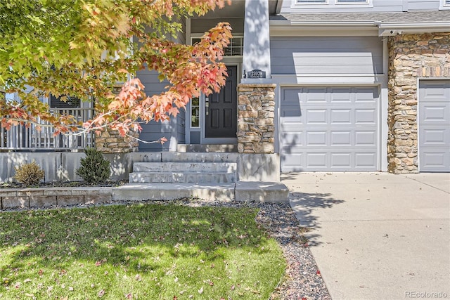 23029 Cleveland Dr, Parker, CO 80138 - property entrance featuring stone siding, a garage, concrete driveway, and a lawn