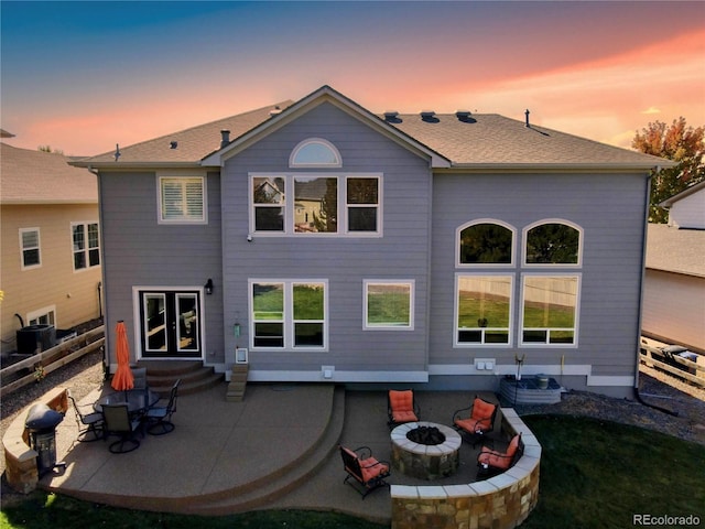 23029 Cleveland Dr, Parker, CO 80138 - back of house at dusk featuring an outdoor fire pit, a patio, and entry steps