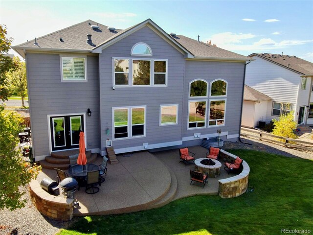 23029 Cleveland Dr, Parker, CO 80138 - rear view of house featuring a fire pit, a patio, and a shingled roof