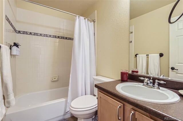 23029 Cleveland Dr, Parker, CO 80138 - bathroom featuring a textured wall, vanity, and shower / bath combo with shower curtain