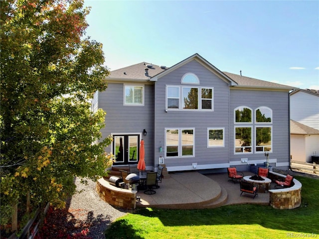 23029 Cleveland Dr, Parker, CO 80138 - rear view of house with an outdoor fire pit, a patio area, and a lawn