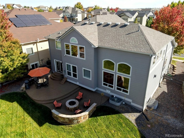 23029 Cleveland Dr, Parker, CO 80138 - back of house with a patio area, a fire pit, a shingled roof, and a lawn