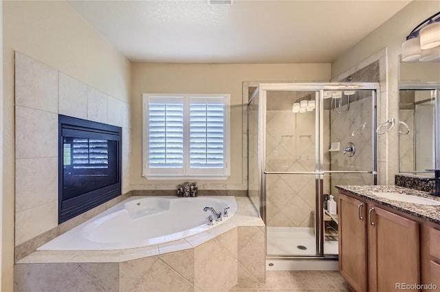 23029 Cleveland Dr, Parker, CO 80138 - bathroom with vanity, a garden tub, a stall shower, and tile patterned flooring
