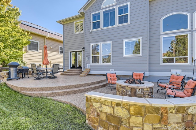 23029 Cleveland Dr, Parker, CO 80138 - back of property with a fire pit, a patio, and entry steps