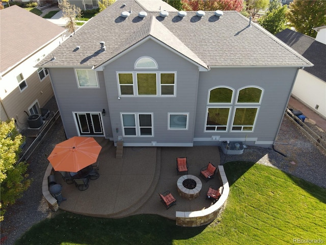 23029 Cleveland Dr, Parker, CO 80138 - rear view of property featuring a patio, an outdoor fire pit, a shingled roof, and a yard