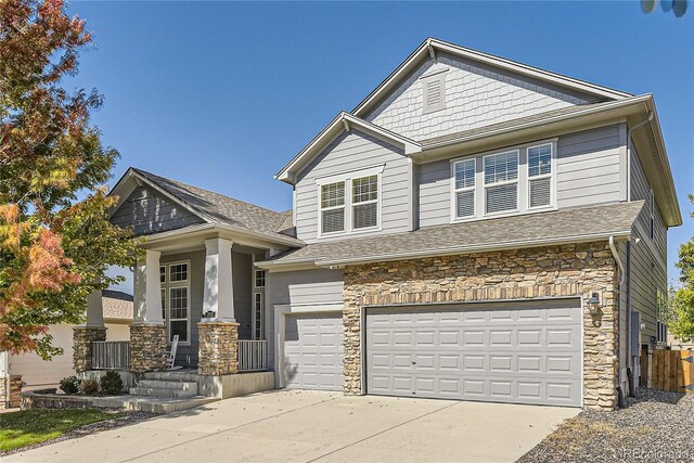 23029 Cleveland Dr, Parker, CO 80138 - view of front of home with stone siding, an attached garage, concrete driveway, and roof with shingles
