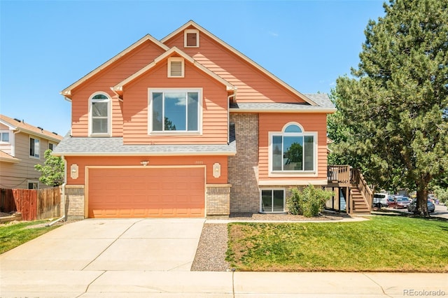 19595 N Mitchell Dr, Denver, CO 80249 - view of front facade with a garage, driveway, brick siding, stairway, and a shingled roof