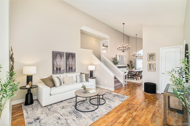 19595 N Mitchell Dr, Denver, CO 80249 - living area with stairs, a chandelier, wood finished floors, and high vaulted ceiling