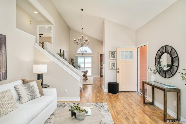 19595 N Mitchell Dr, Denver, CO 80249 - living area with high vaulted ceiling, stairway, a chandelier, light wood-style flooring, and recessed lighting