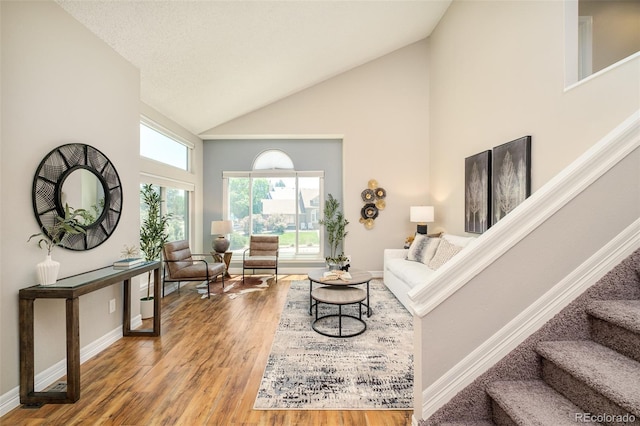 19595 N Mitchell Dr, Denver, CO 80249 - living room with high vaulted ceiling, wood finished floors, and stairs