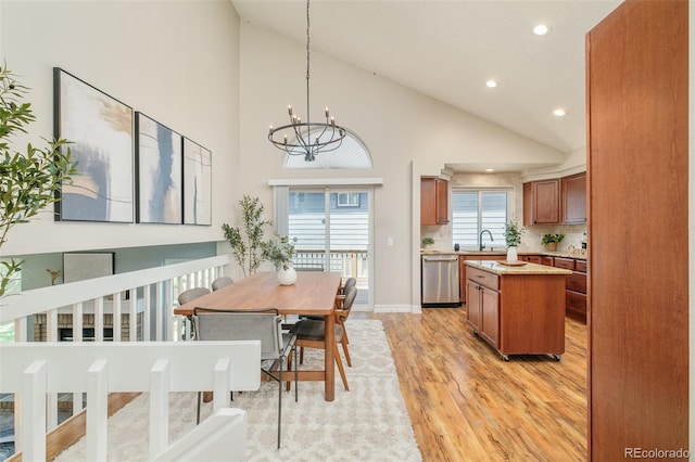 19595 N Mitchell Dr, Denver, CO 80249 - dining room featuring light wood-style flooring, recessed lighting, a chandelier, and high vaulted ceiling