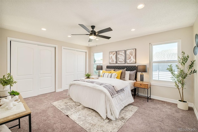 19595 N Mitchell Dr, Denver, CO 80249 - carpeted bedroom with multiple closets, multiple windows, recessed lighting, and ceiling fan