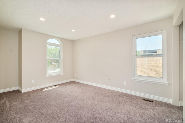 19595 N Mitchell Dr, Denver, CO 80249 - empty room featuring carpet flooring, recessed lighting, and a textured ceiling