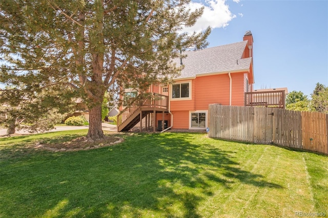 19595 N Mitchell Dr, Denver, CO 80249 - back of property featuring stairs, a deck, a chimney, and a shingled roof