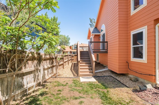 19595 N Mitchell Dr, Denver, CO 80249 - fenced backyard featuring a wooden deck and stairway