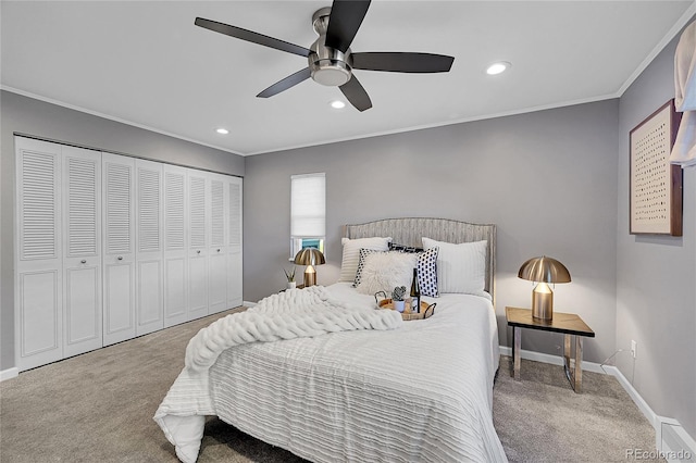 bedroom with a closet, ornamental molding, carpet, and ceiling fan