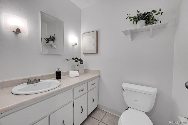 bathroom with vanity, toilet, and tile patterned flooring