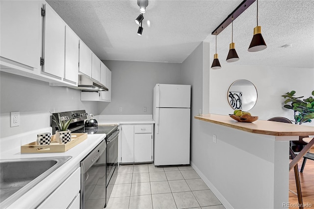 kitchen with appliances with stainless steel finishes, white cabinetry, a textured ceiling, and pendant lighting