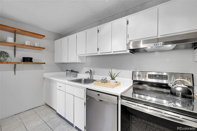 kitchen featuring light tile patterned flooring, sink, a textured ceiling, white cabinetry, and stainless steel appliances