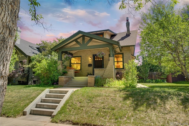 2236 Forest St, Denver, CO 80207 - view of front of property with covered porch, brick siding, and a chimney