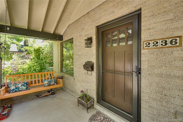 2236 Forest St, Denver, CO 80207 - doorway to property featuring a porch and brick siding