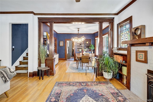 2236 Forest St, Denver, CO 80207 - entrance foyer with a chandelier, wood finished floors, crown molding, baseboards, and stairway